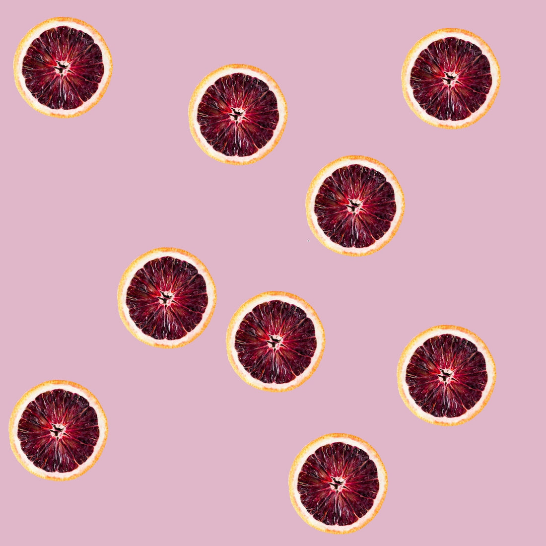 a group of grapefruits on a pink background